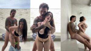 Muscular tattooed man and woman intimately embracing in modern minimalist setting - HornySimp
