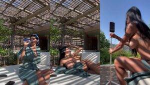 Nude woman on outdoor daybed under pergola