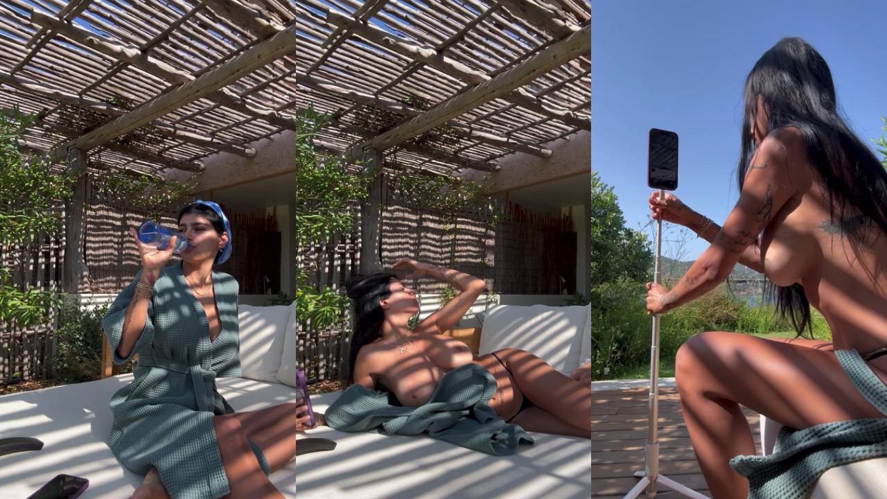 Nude woman on outdoor daybed under pergola