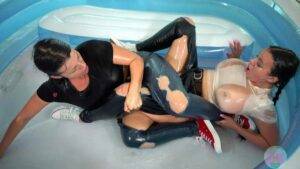 Oiled women wrestling in torn jeans