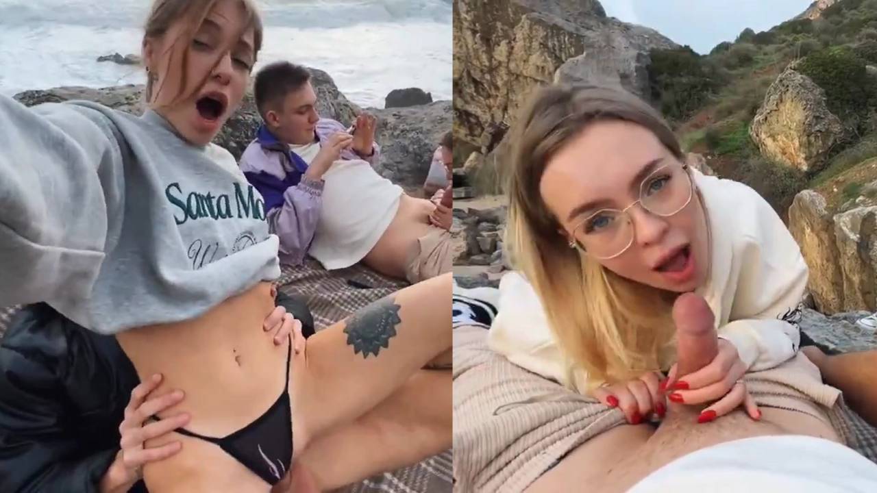 Two women swapping partners outdoors on a rocky cliff picnic blanket. - HornySimp